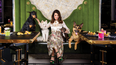 Lisa Vanderpump poses with a few canine friends at the Vanderpump Cocktail Garden at the Caesars Palace Las Vegas.